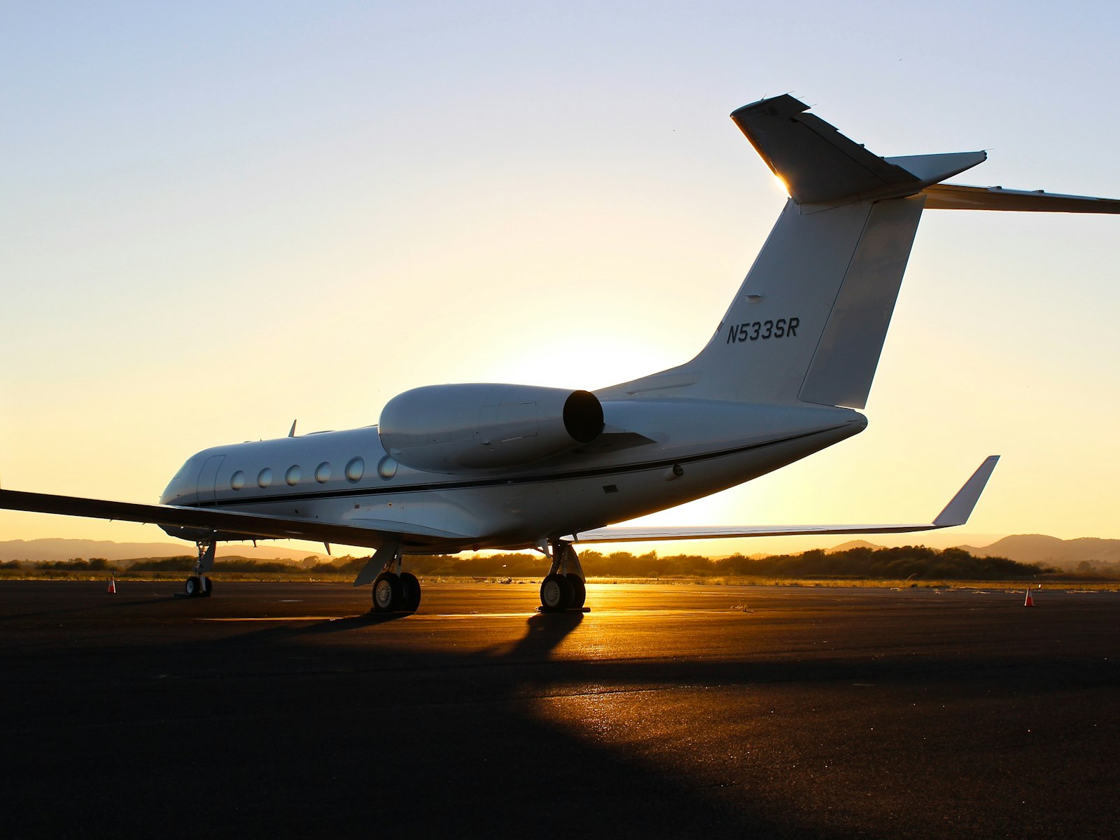 Private jet on the tarmac at sunset